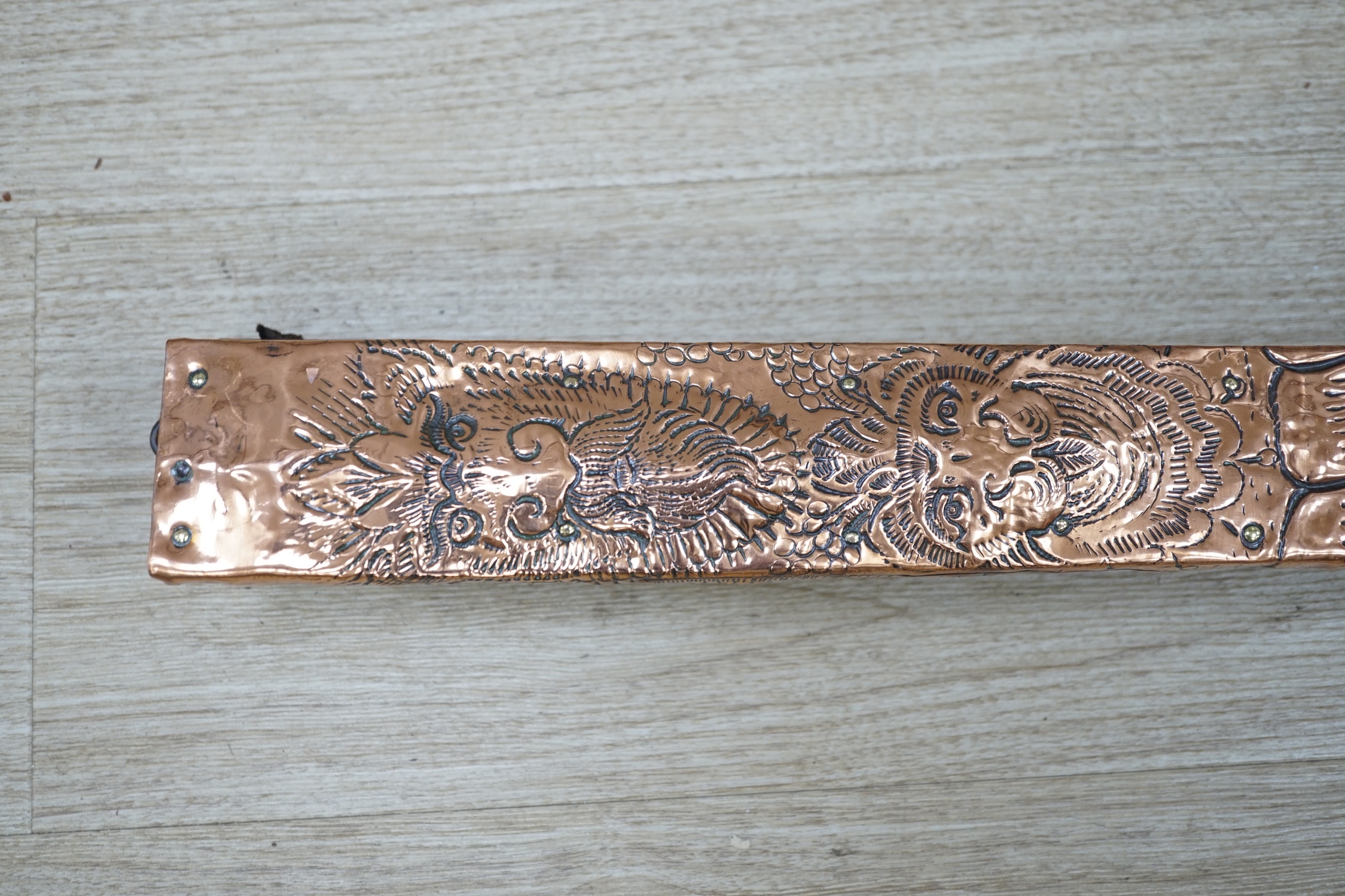 A pair of early 20th century copper bellows embossed with fauns, 81cm in length. Condition - fair